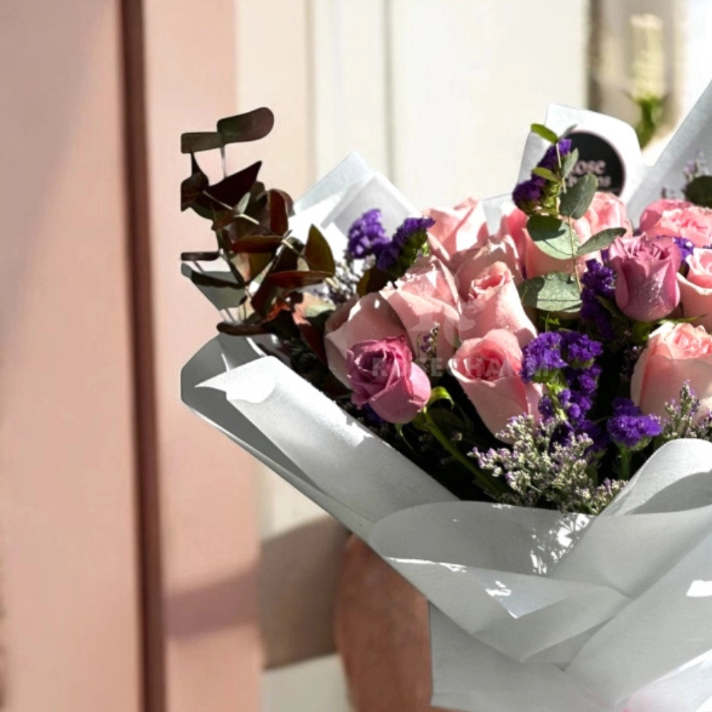 pink and purple roses bouquet in a nice wrapping