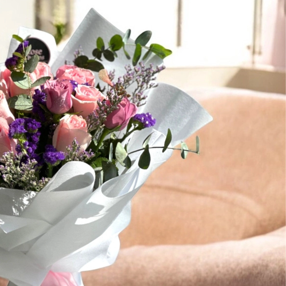 pink and purple roses bouquet in a nice wrapping