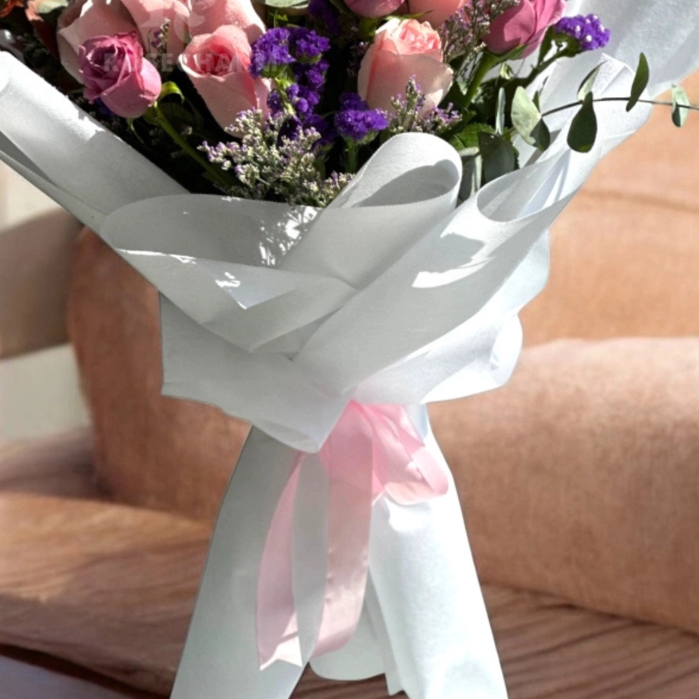 pink and purple roses bouquet in a nice wrapping