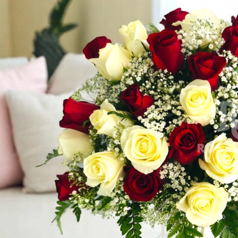Arrangement of red and white roses in a glass vase