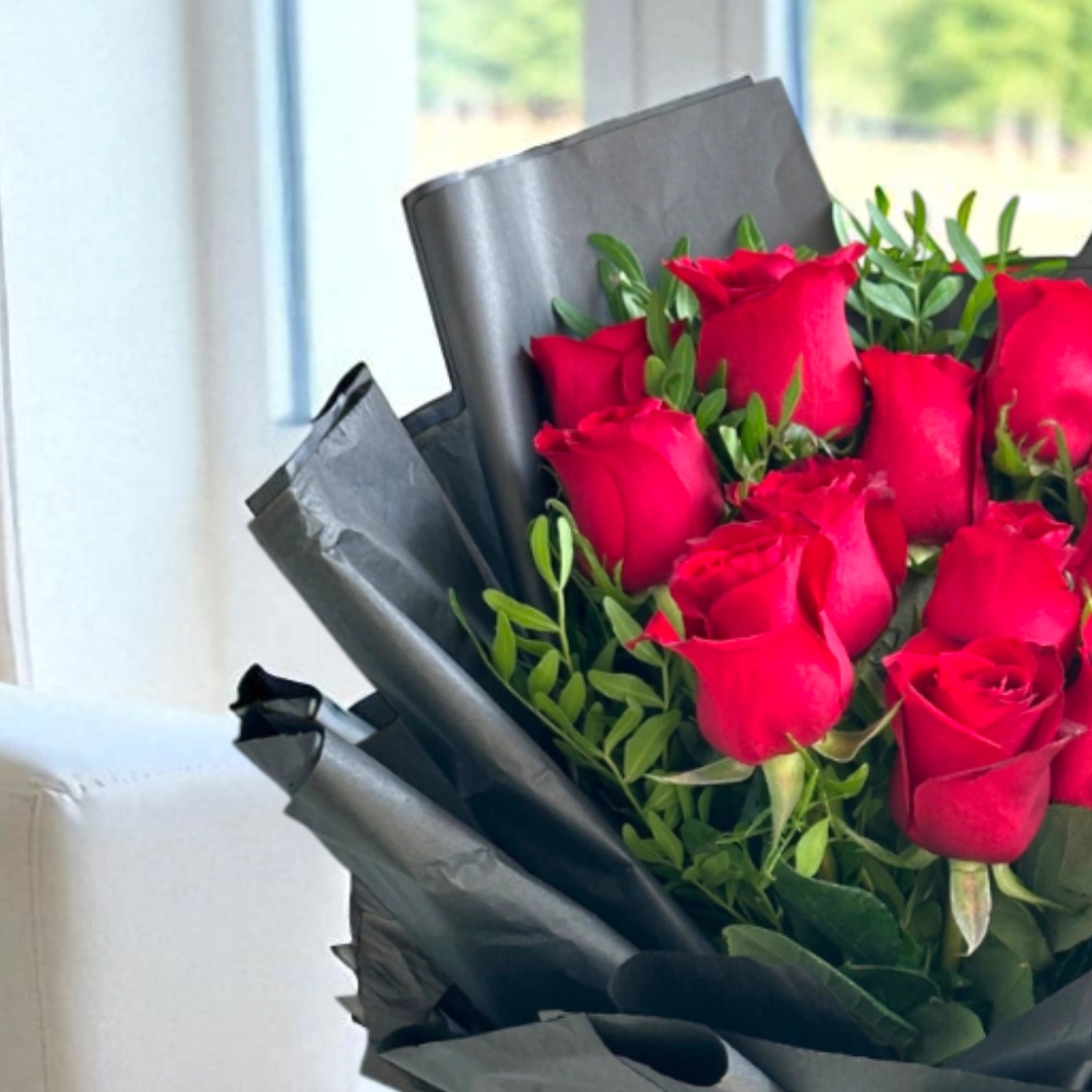 A bouquet of 12 red roses with fillers in a nice wrapping