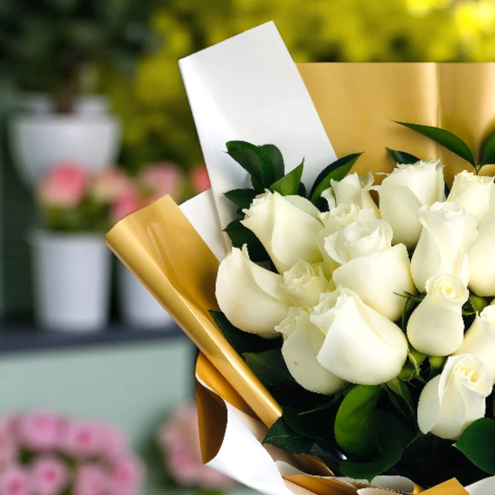 A bouquet of 25 white roses with fillers in a nice wrapping