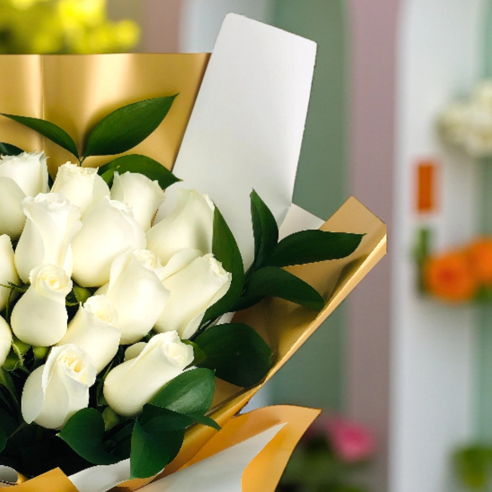 A bouquet of 25 white roses with fillers in a nice wrapping