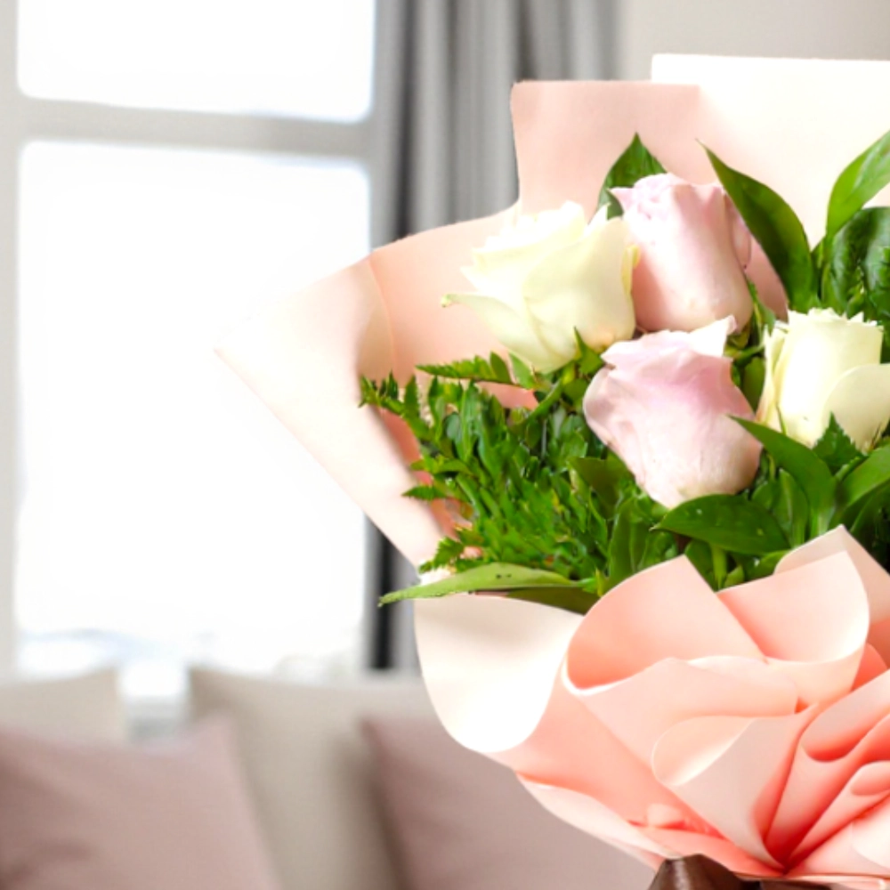 A bouquet of 6 white and pink roses in a nice wrapping