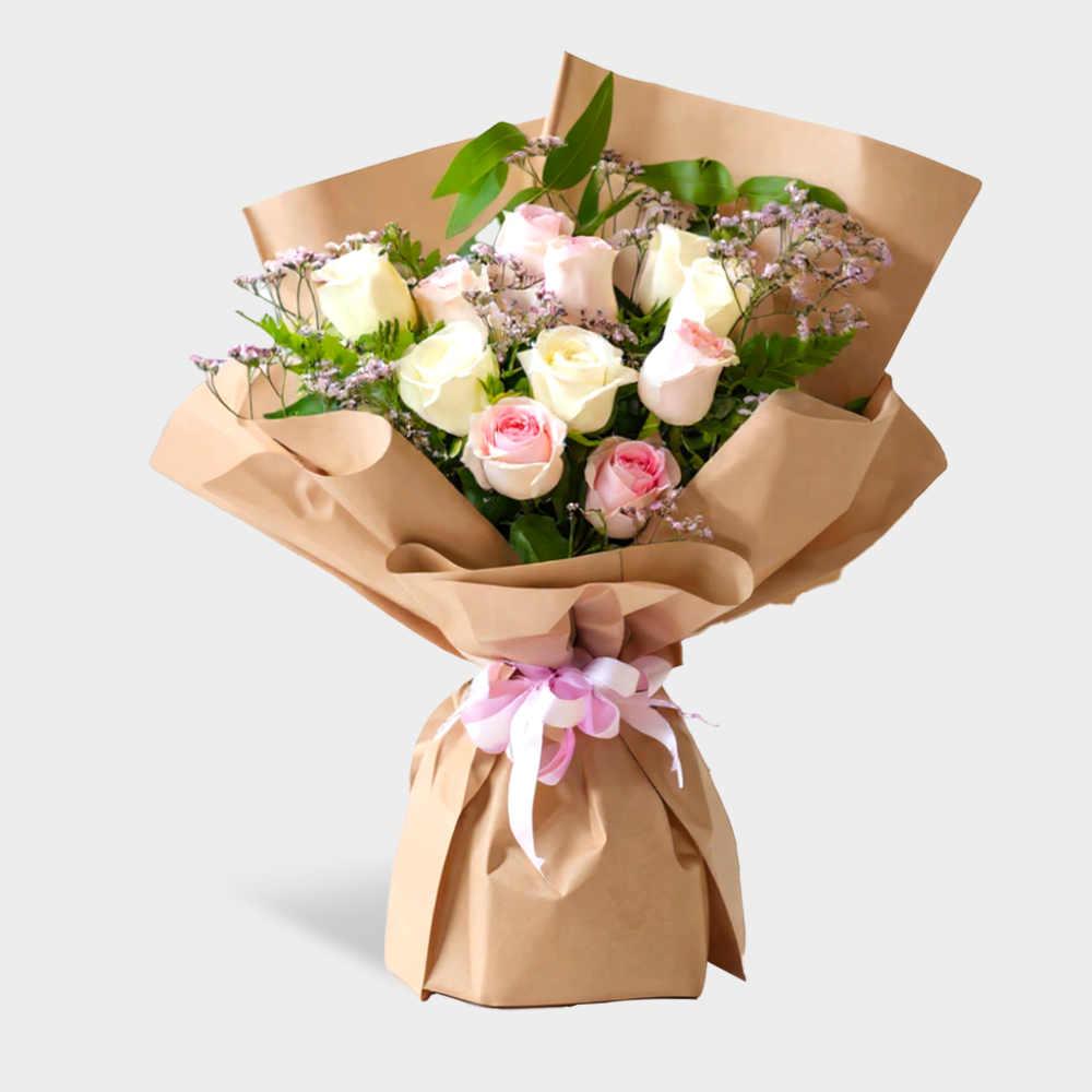 A bouquet of white and pink roses in a nice wrapping