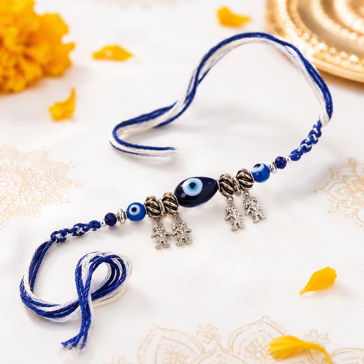 Blue Evil Eye Rakhi with sibling charm pendants, decorative beads, and blue braided thread for Raksha Bandhan