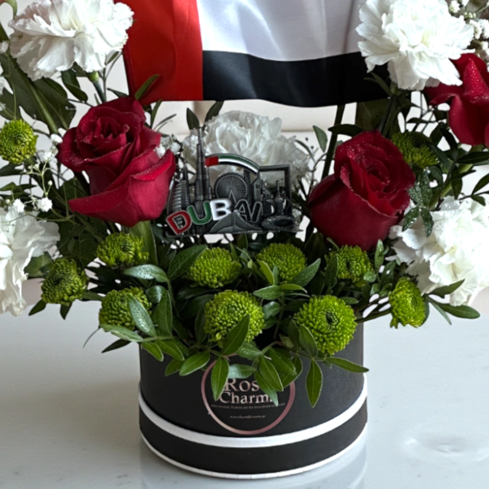 Arrangement of UAE color roses and chrysanthemum in a box