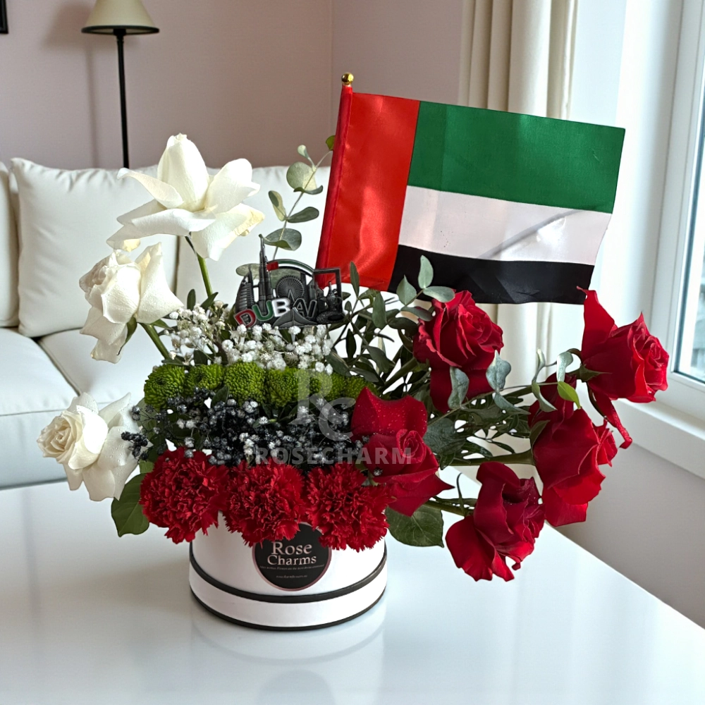 Arrangement of roses and chrysanthemums in a white box