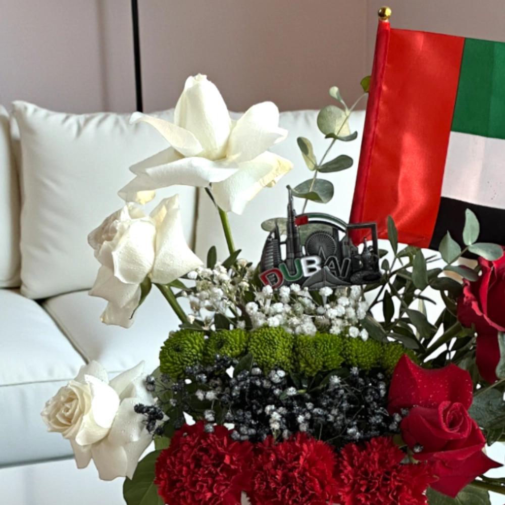 Arrangement of roses and chrysanthemums in a white box