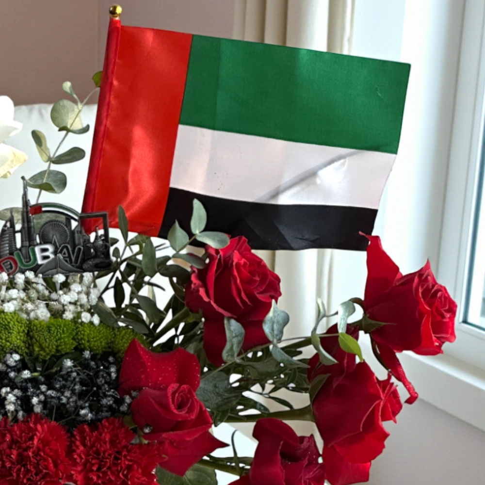 Arrangement of roses and chrysanthemums in a white box