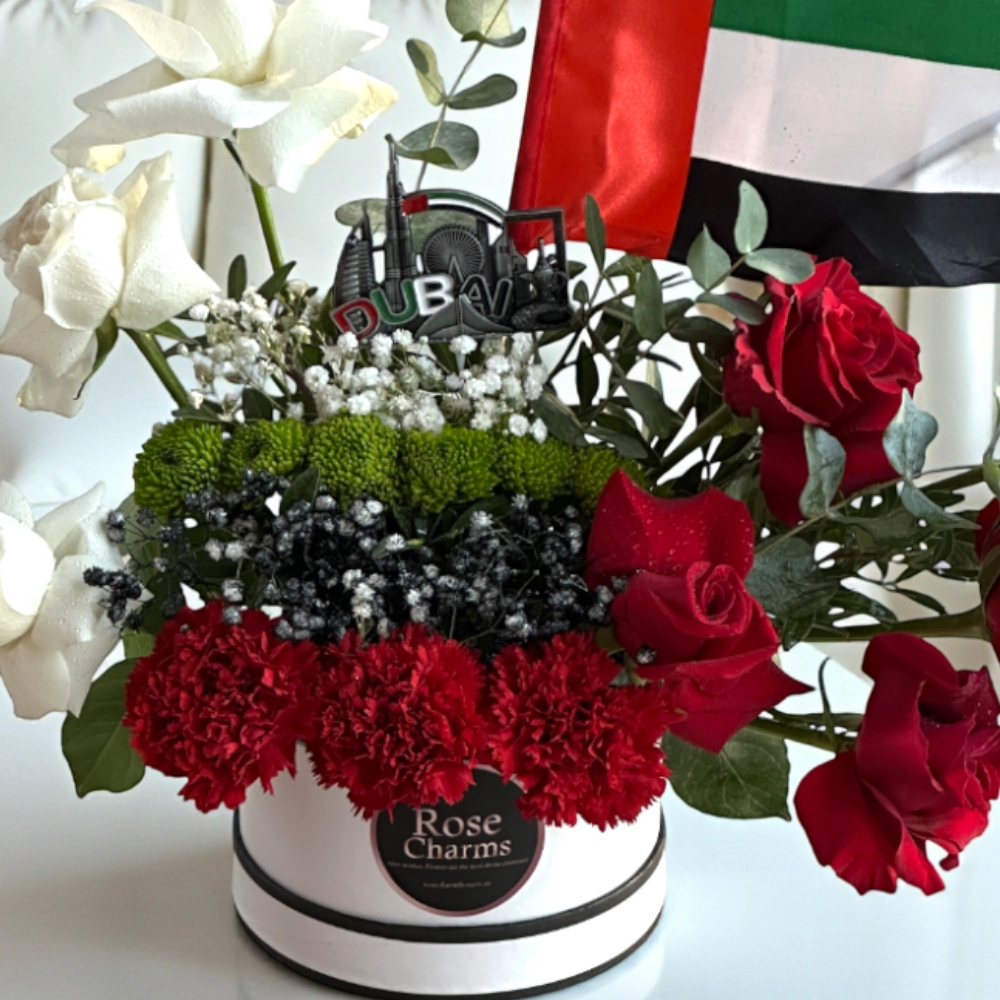 Arrangement of roses and chrysanthemums in a white box