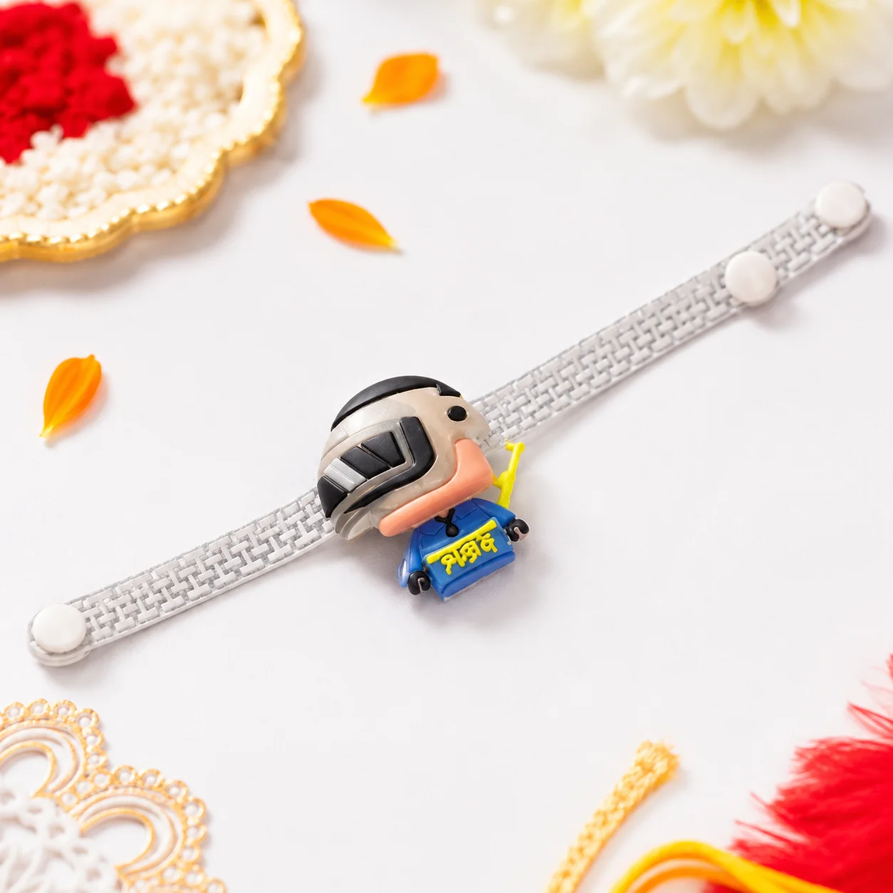 A fun kids' rakhi featuring a popular PUBG character figurine on a comfortable white adjustable strap for little brothers.