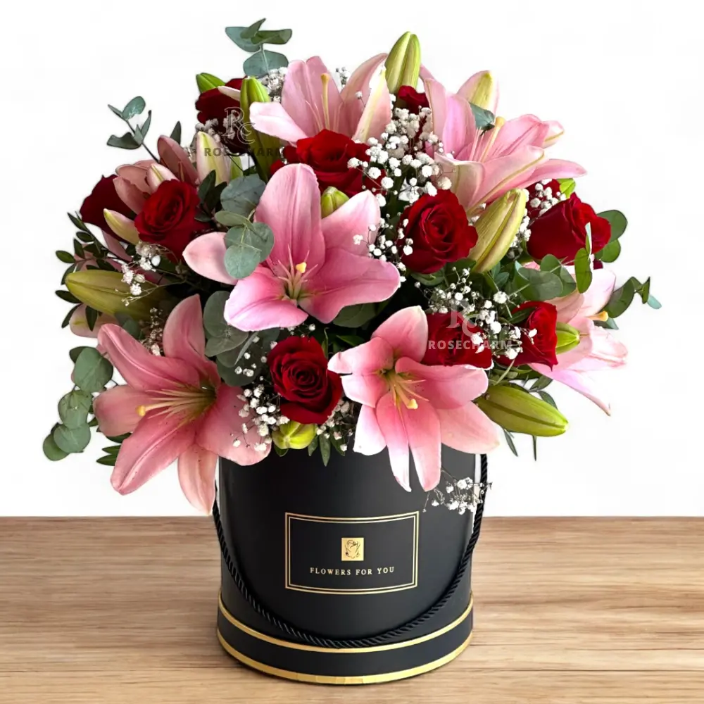 Arrangement of red roses & pink lilies in a box