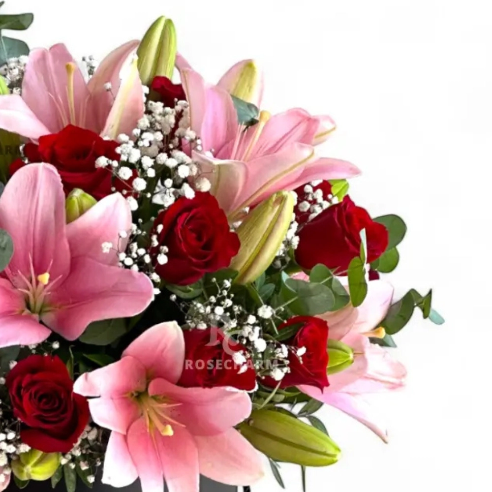 Arrangement of red roses & pink lilies in a box