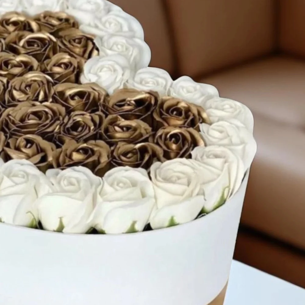 Hearts shape white and gold rose arrangement in a box