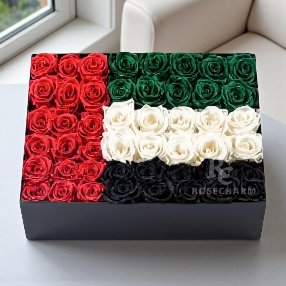 Arrangement of 50 - 60 UAE flag color roses in a black box