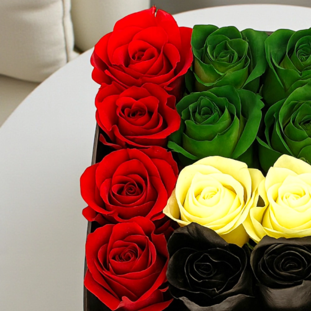 Arrangement of 16Pcs UAE flag color roses in a black box