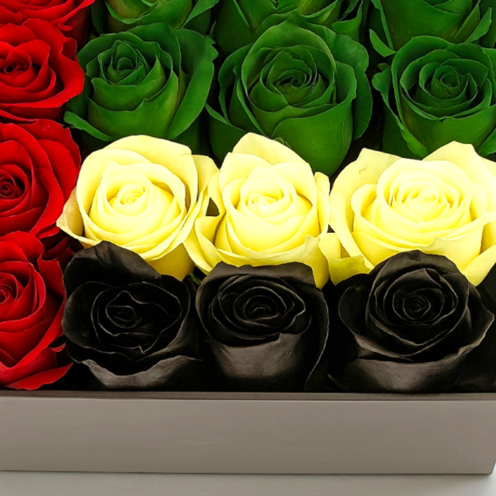 Arrangement of 16Pcs UAE flag color roses in a black box