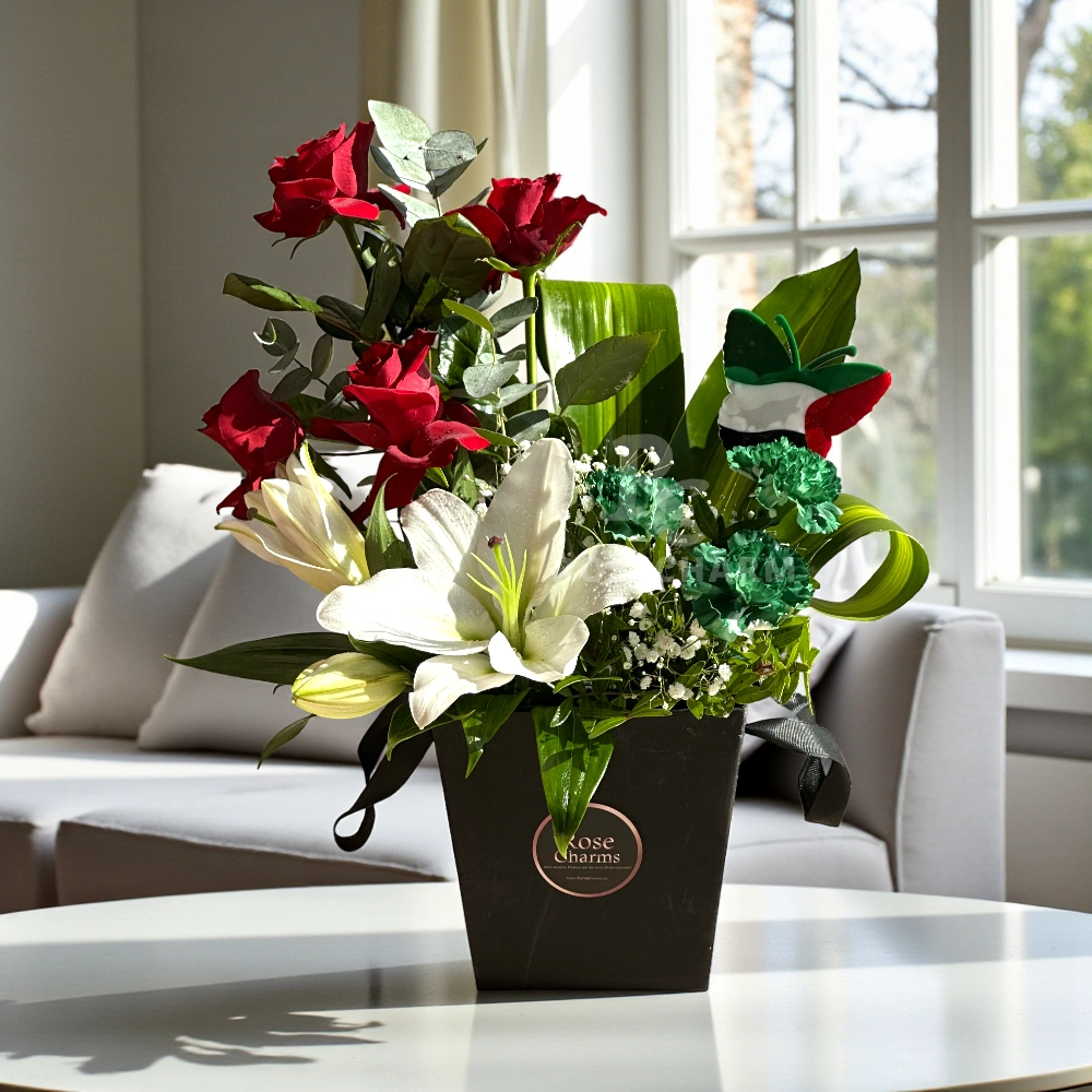 Arrangement of UAE color lilies and roses in a box
